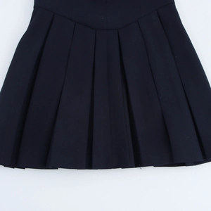 Detail shot of black pleated dress fabric texture with smooth waistband and dense folds