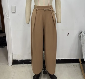 Detail view of khaki high-waisted wide-leg trousers with elegant matching belt and pleats
