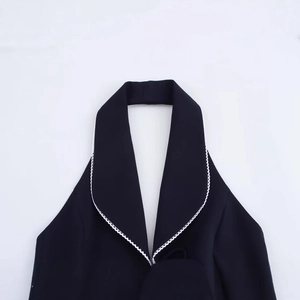 Women's black halter top with contrasting white lace trim and lapel collar design