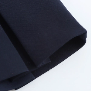 Close-up of navy blue dress featuring high-quality twill weave fabric texture and detail