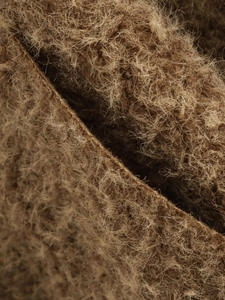 Gros plan sur la texture de laine marron avec des détails de fibres pour vestes femmes