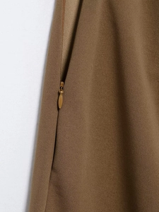 Detail view of high waist trousers showing high-quality invisible zipper and brown woven fabric