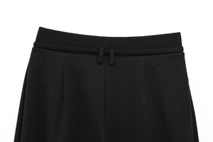 Detail of high-waist black wide-leg trousers with double belt loops and pleated front