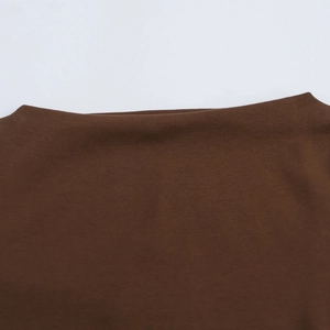 Detailed macro view of the dark brown knitted fabric texture and premium stitching