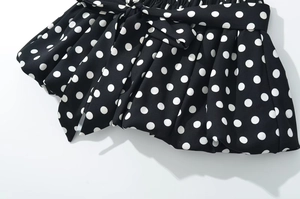 Detailed view of polka dot shorts with elastic waist and matching fabric bow belt