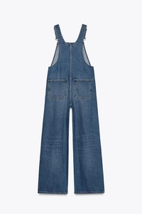 Detail of blue denim overalls back view with wide leg cut and large patch pockets