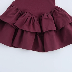 Detail of multi-layered pleated ruffle hem on a wine red elegant dress fabric