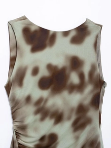 Detail of ruched side seam with invisible zipper on brown and green gradient mini dress