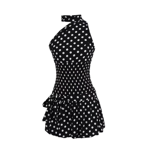 Black and white polka dot sleeveless halter neck top with ruffled hem and smocked waist