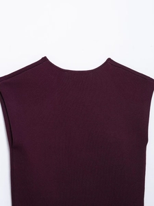 Dettaglio del top in maglia bordeaux che mostra le cuciture fini e la trama del tessuto