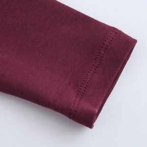 Detailed close-up showing the double-needle stitching on burgundy knitted dress sleeves