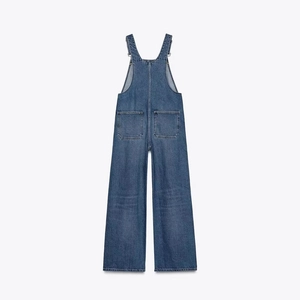 Back view of blue denim dungarees with wide leg cut and adjustable straps