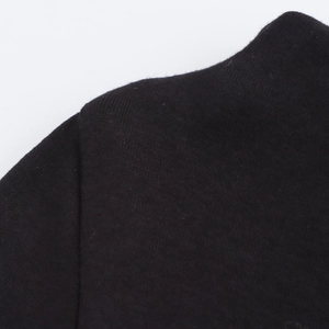 Close-up of high-quality stitching and fine knit fabric on this black mini dress