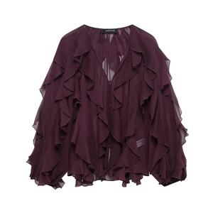 Detailed view of layered vertical ruffles on deep purple chiffon blouse with v-neckline