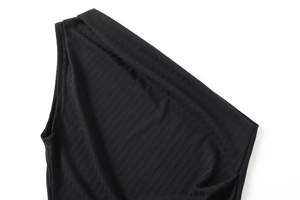 Detailed close-up of premium black ribbed knit fabric texture on a modern women's top