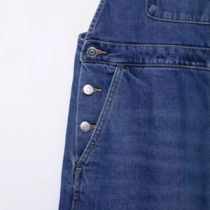 Classic blue denim overalls for women with silver metal buttons and brown contrast stitching