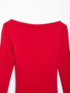 Detail of red boat neck long sleeve dress showing fine knit texture and shoulder design