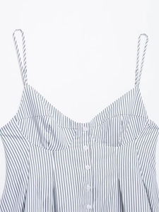Detailed macro of the V-neckline with white buttons on a striped camisole top