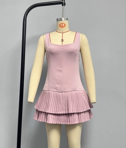 Close-up of pink sleeveless mini dress featuring double-layered pleated skirt and square neck