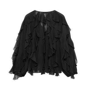 Detailed view of black chiffon top featuring multi-layered vertical ruffles and elastic cuffs