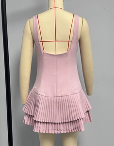 Detail of pink sleeveless mini dress featuring double-layered pleated skirt and open back