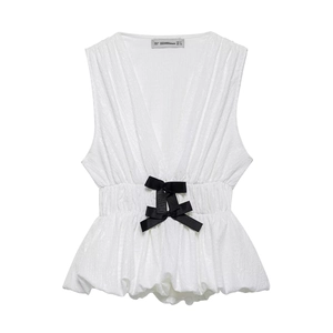 White V-neck sleeveless top with black waist bow and textured pleated fabric detail