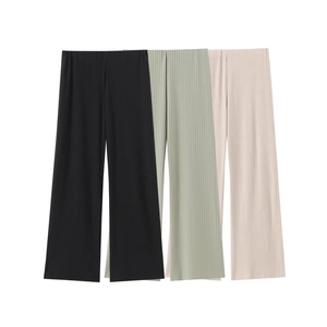 Detail showing high-waisted pleated wide-leg pants in black, beige, and sage green fabric