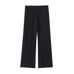 Detailed macro view of black high-waisted wide-leg trousers with vertical pleated texture