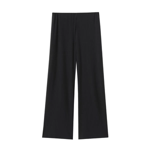 Detail of black pleated wide-leg trousers featuring elastic high waist and vertical texture
