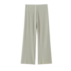Detailed view of sage green pleated wide-leg trousers with vertical texture and flowy fabric