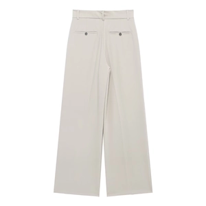 Rear view detail of high-waisted off-white trousers with faux pockets and grey button