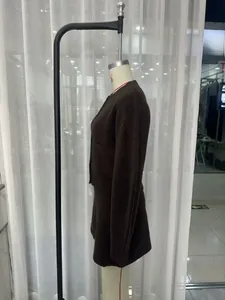 Detailed texture of dark brown knit cardigan set with elegant gold buttons for women