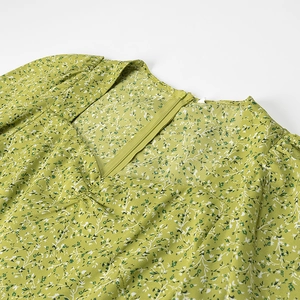 Green floral dress with puff sleeves and square neckline featuring a back zipper closure