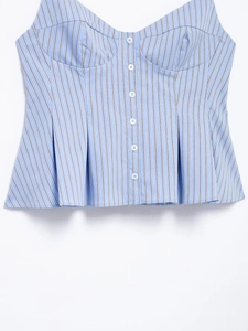 Detail of blue striped corset top with white buttons and flared ruffle hem texture