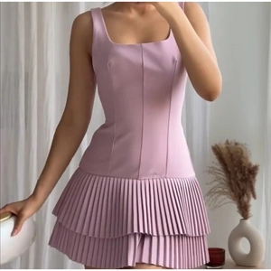 Detail view of pink square neck sleeveless mini dress with double-layered pleated hem