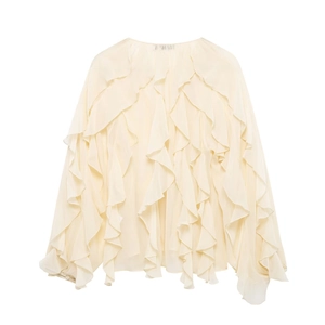 Detailed view of layered chiffon ruffles and elegant button cuffs on a cream blouse