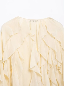 Detailed close-up of tiered ruffle layers on this elegant beige chiffon blouse for women