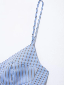 Detailed view of blue and brown vertical stripes and fine shoulder straps on summer top