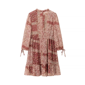 Detail of bohemian floral dress featuring ruffled collar and decorative bow-tie cuffs