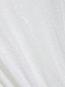 Detailed macro view of white paisley jacquard fabric showing intricate woven textures