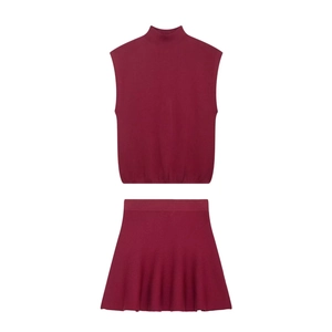 Women's burgundy sleeveless knit set featuring high-neck top and pleated mini skirt