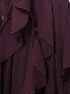 Detailed macro shot of deep purple layered chiffon fabric texture and ruffled edges