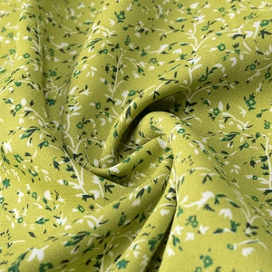 Detailed macro view showing the light green floral print fabric texture and drapery