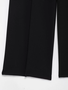 Detailed close-up showing the high-quality stitching and fabric of black wide-leg trousers