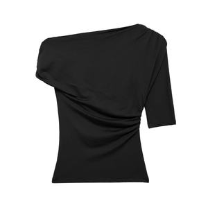 Detail of black one-shoulder top showing asymmetrical cut and pleated side drapery