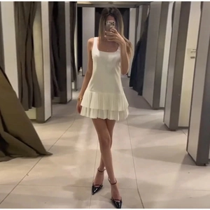 White sleeveless mini dress with double-layered pleated hem and elegant square neckline