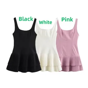 Detailed view of sleeveless mini dresses in black, white, and pink with pleated hem