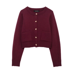 Detailed view of burgundy knit cardigan featuring gold embossed buttons and square pockets