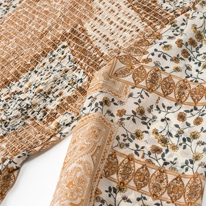 Close-up of smocked elastic bodice with paisley and vintage floral prints on woven fabric