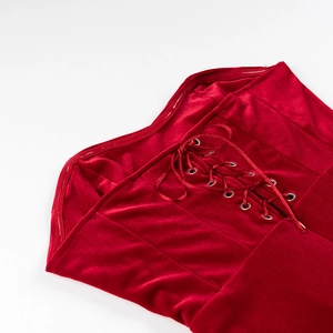 Gros plan détaillé sur le tissu en velours rouge avec laçage style corset et œillets